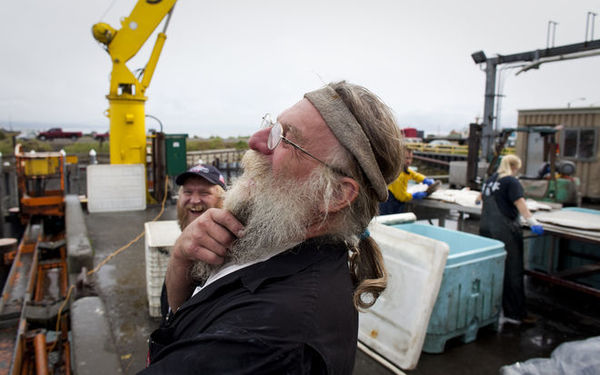 Dan Anderson shares a laugh with friends at the dock in Homer, Alaska